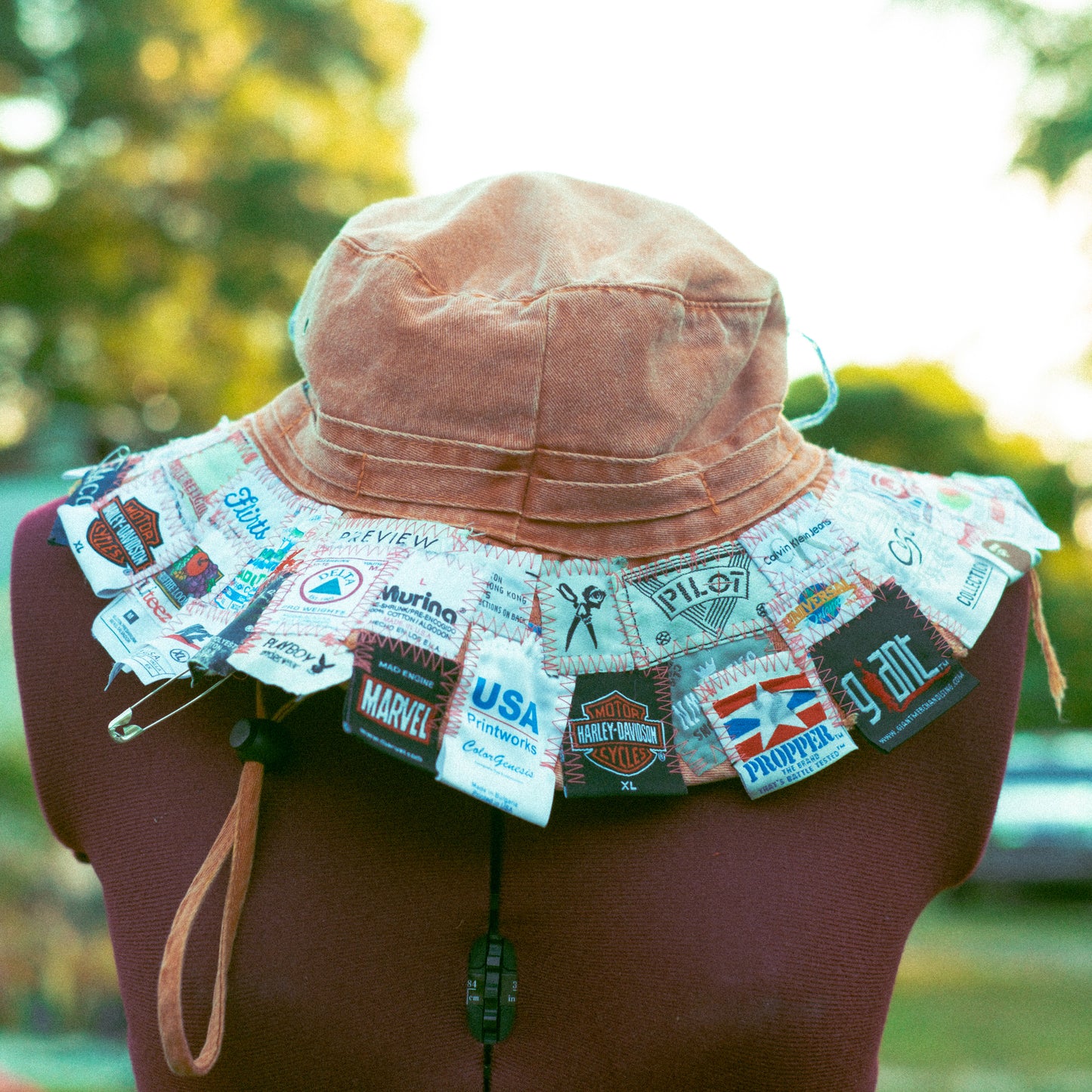 FADED ORANGE TAG PATCHED BUCKET HAT